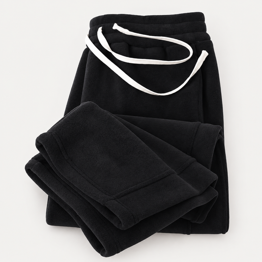 FleeceFlow Relaxed Trousers in Black on a warm light-grey studio background