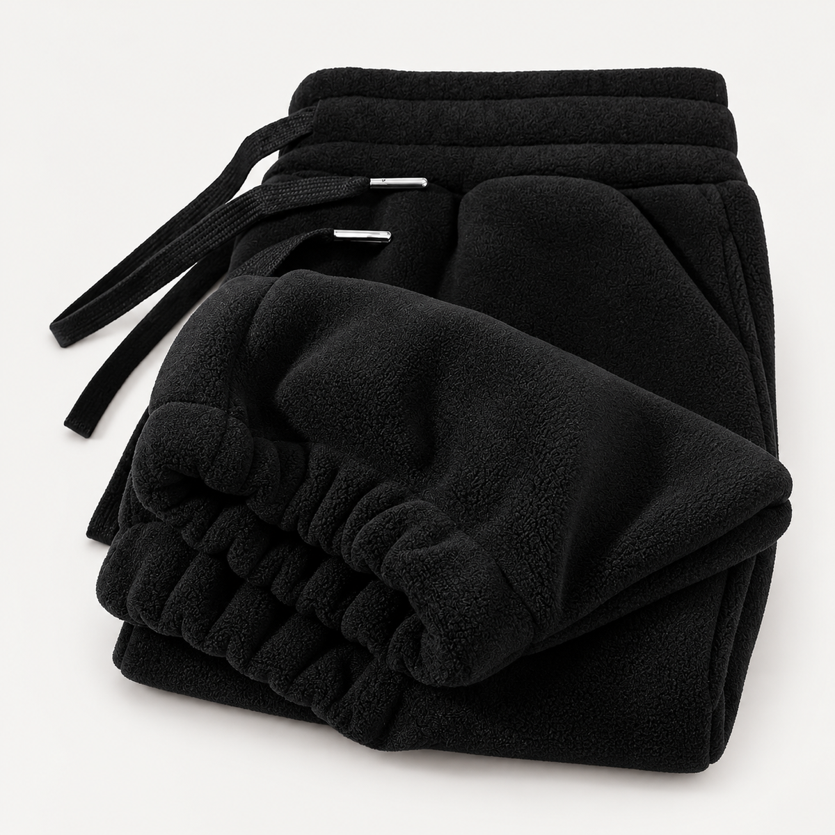 ThermaEase Fleece Joggers in Black on a warm light-grey studio background